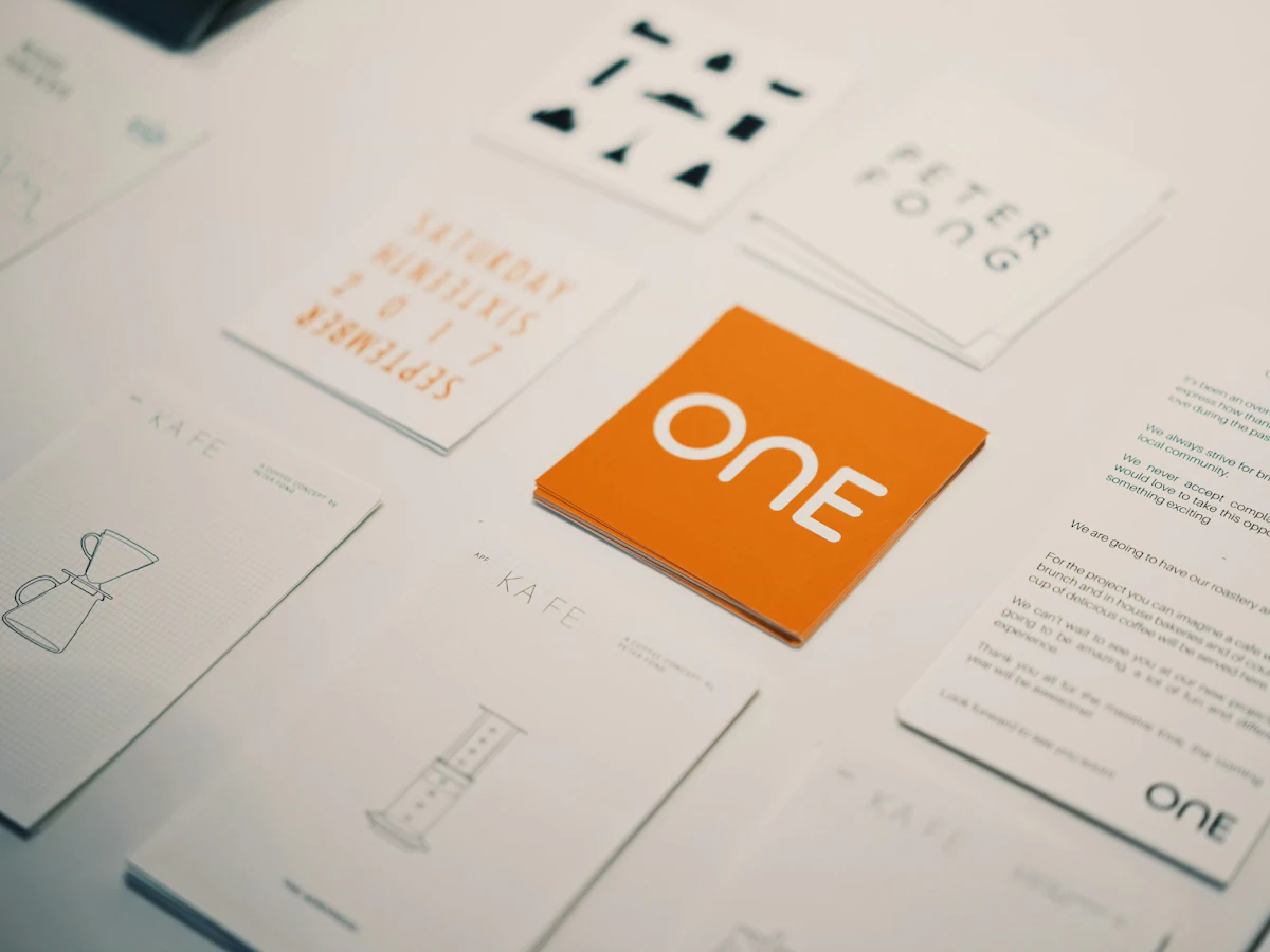 Cards and stationery from a brand identity with an orange logo.