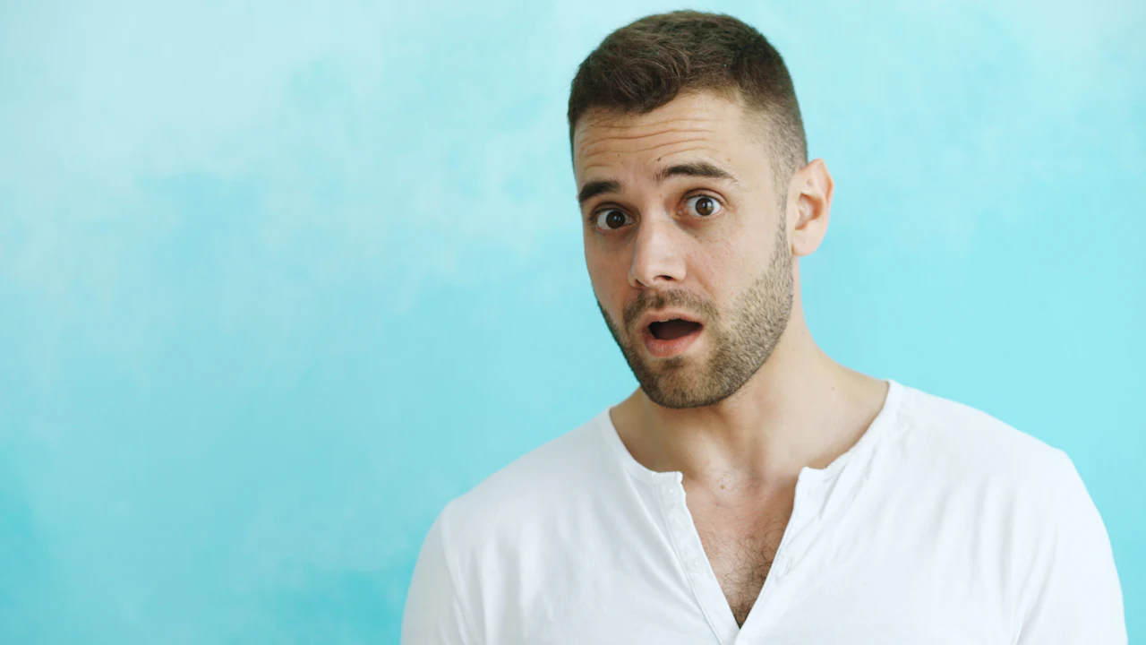 Surprised man on a light blue background.