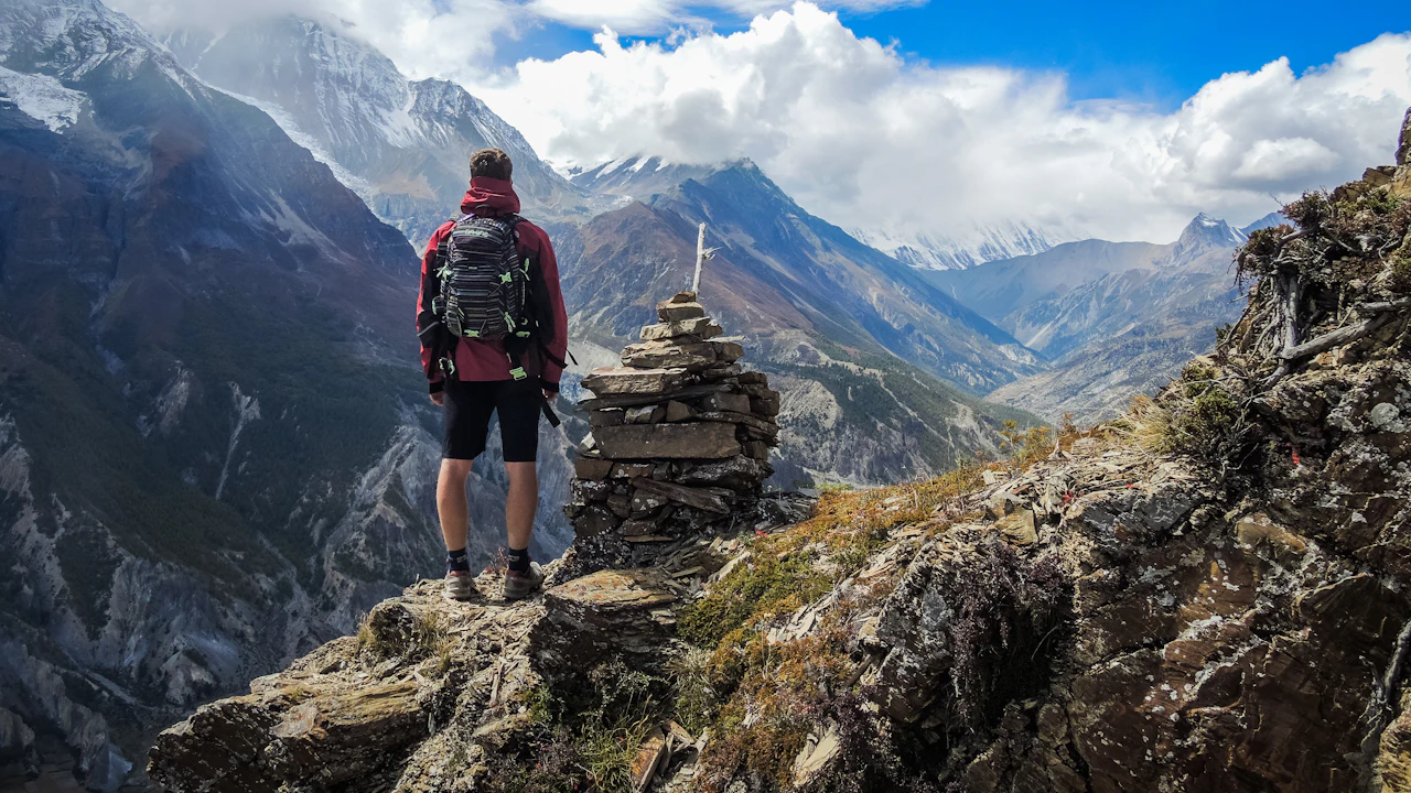 Hiker with a backpack on a mountain top.